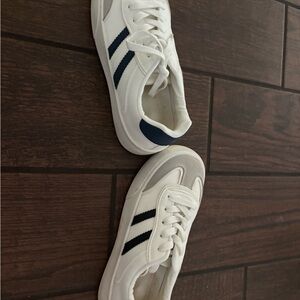 Two pairs of new white sneakers- Navy Stripes & black stripes. Size 7.